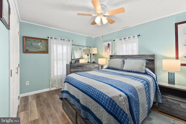 bedroom with wood-type flooring, a textured ceiling, ceiling fan, and ornamental molding