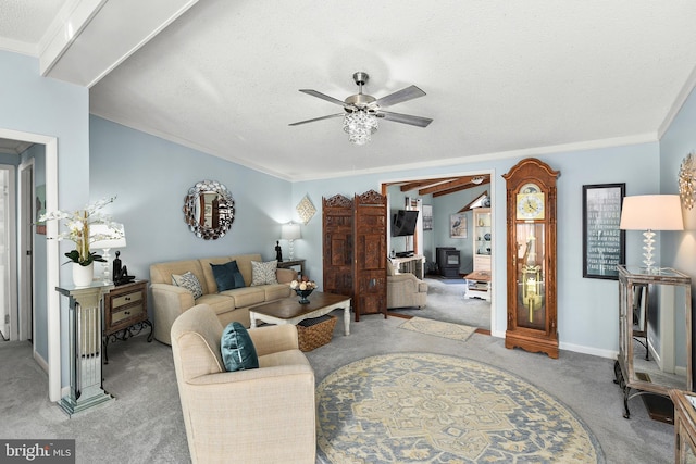 carpeted living room featuring a textured ceiling, ceiling fan, and crown molding