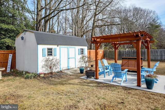 exterior space featuring a lawn, a pergola, an outdoor fire pit, and a patio