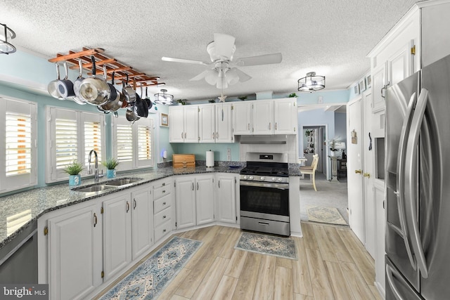 kitchen with white cabinets, sink, and appliances with stainless steel finishes