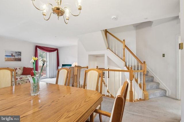 carpeted dining space featuring an inviting chandelier