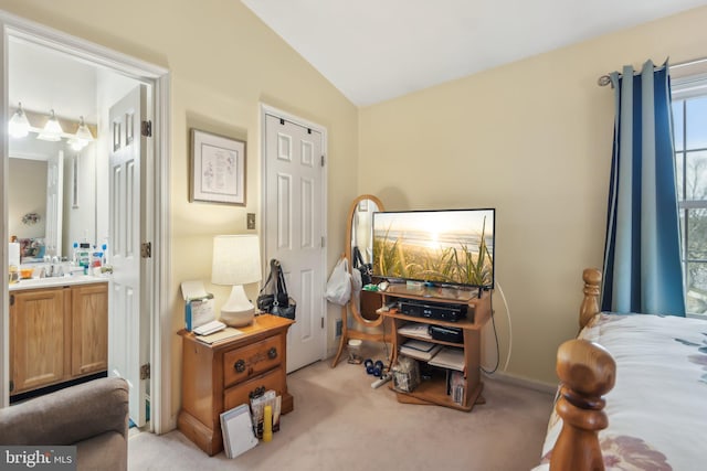 carpeted bedroom with a closet and vaulted ceiling