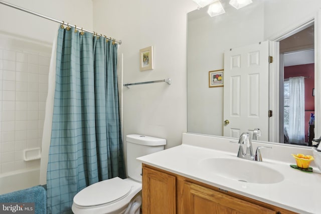 full bathroom with shower / bath combo, vanity, and toilet