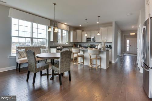 dining area featuring dark hardwood / wood-style flooring and an inviting chandelier