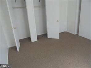 unfurnished bedroom featuring light carpet