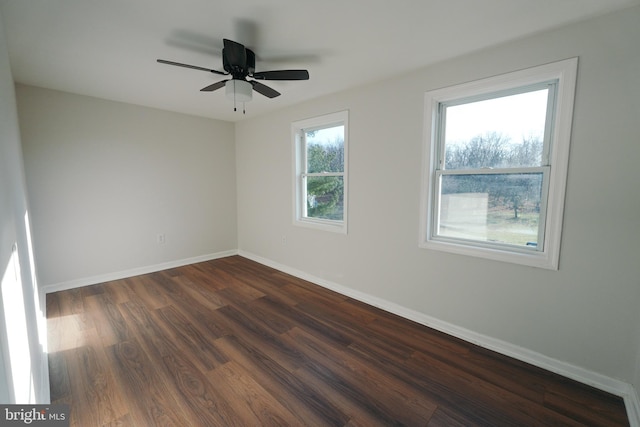 spare room with ceiling fan and dark hardwood / wood-style floors