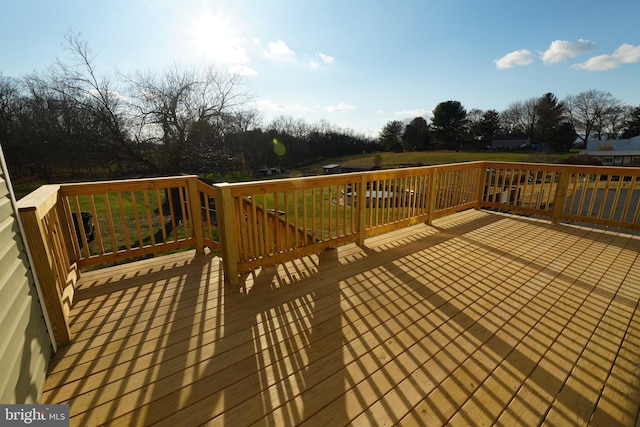 wooden deck with a lawn