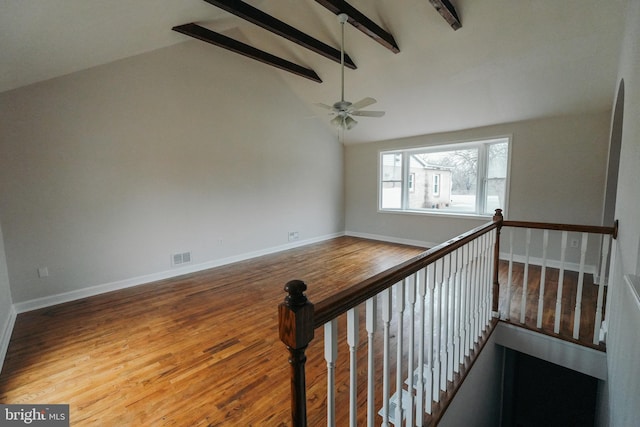 stairs with beamed ceiling, ceiling fan, high vaulted ceiling, and hardwood / wood-style flooring