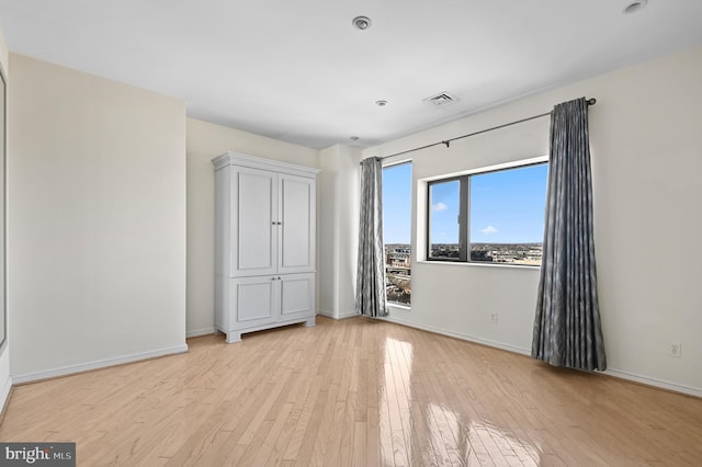 unfurnished bedroom with light wood-type flooring