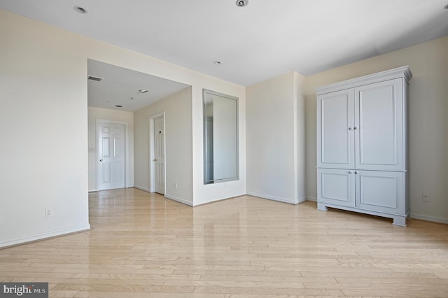 unfurnished room with light wood-type flooring