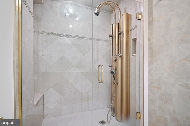 bathroom with a shower with shower door