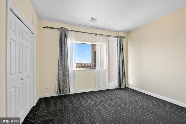 unfurnished bedroom with carpet floors and a closet