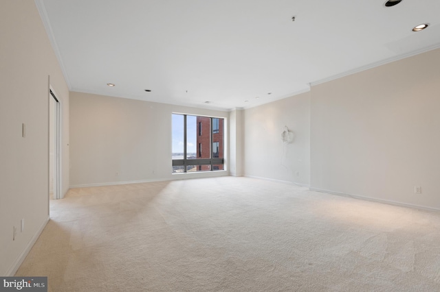 carpeted spare room with crown molding