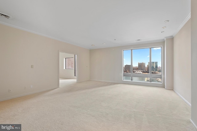 carpeted empty room featuring ornamental molding