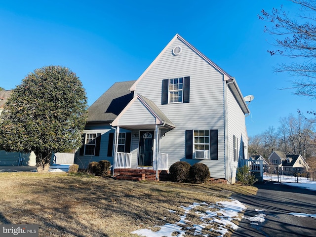 front of property with cooling unit and a front lawn