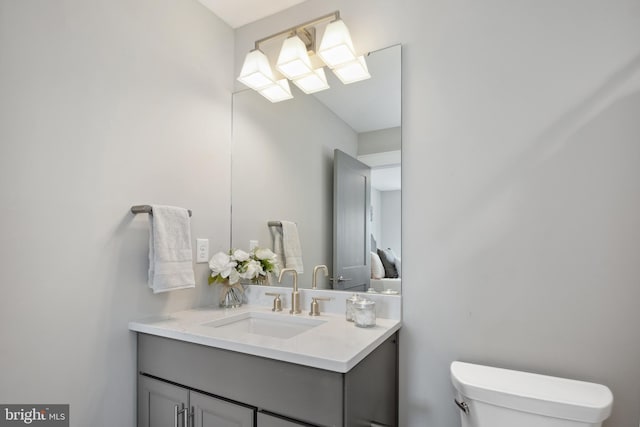 bathroom with toilet and vanity