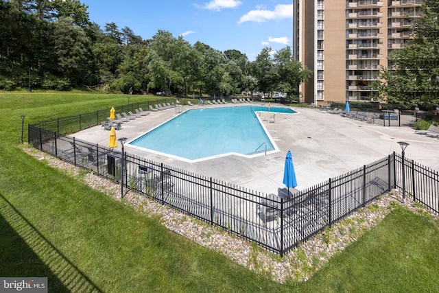 view of pool featuring a patio and a lawn