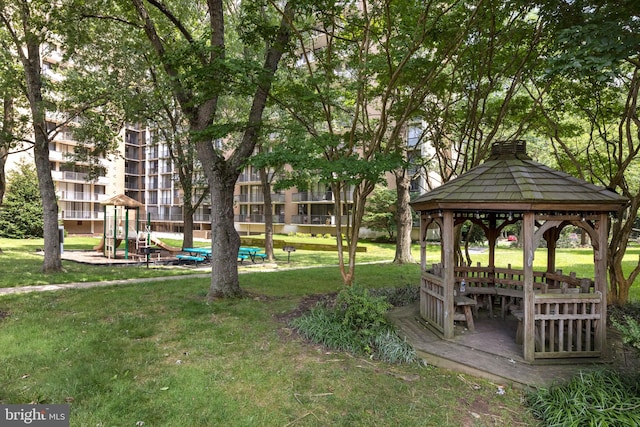 surrounding community featuring a gazebo, a playground, and a lawn