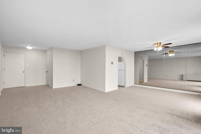 unfurnished room featuring ceiling fan and light colored carpet