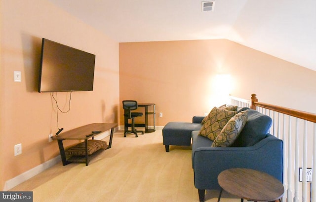 sitting room featuring lofted ceiling and light carpet