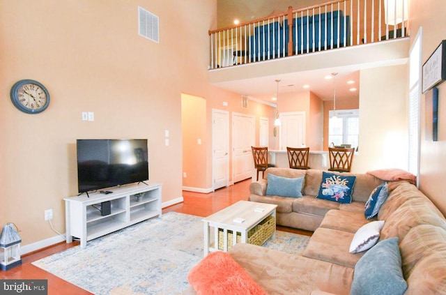 living room featuring a towering ceiling