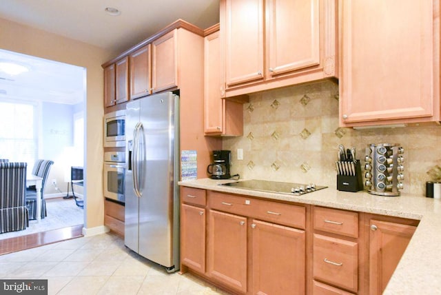 kitchen featuring light tile patterned floors, appliances with stainless steel finishes, and tasteful backsplash