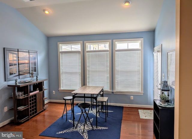 dining area with vaulted ceiling, dark hardwood / wood-style floors, and plenty of natural light