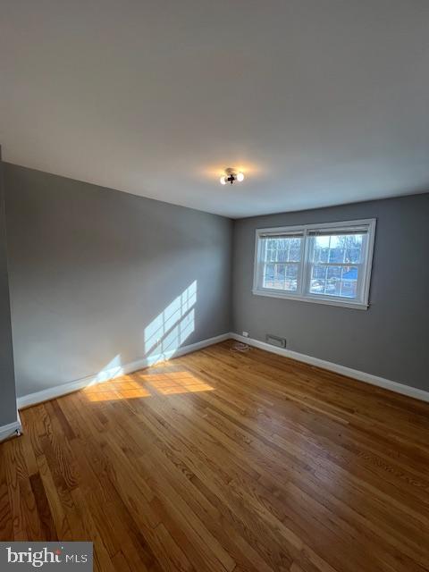 spare room with hardwood / wood-style flooring