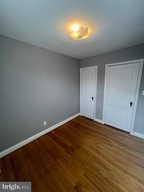 unfurnished bedroom with hardwood / wood-style floors and a closet