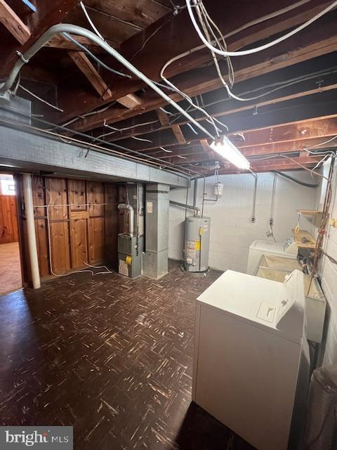 basement with separate washer and dryer, water heater, and heating unit