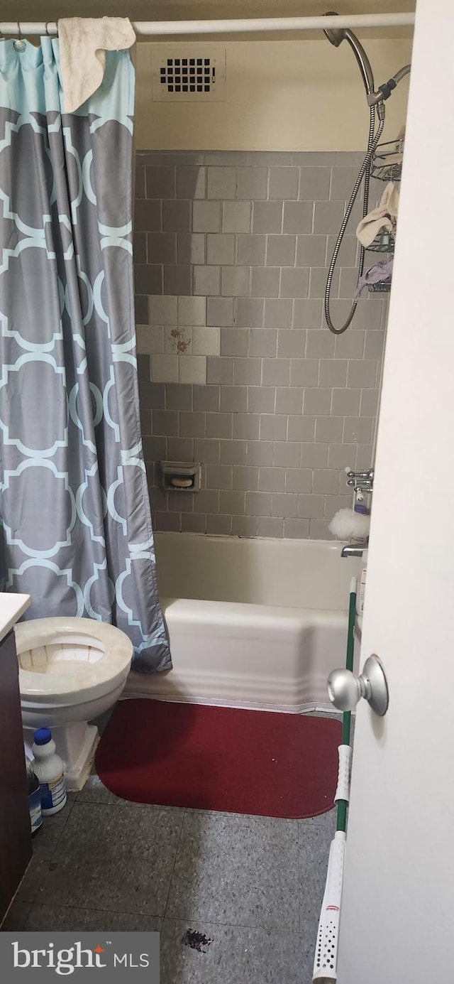 bathroom with toilet and shower / tub combo