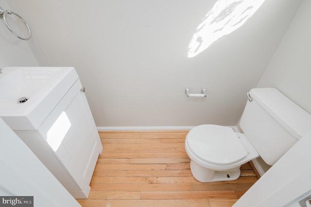 bathroom with hardwood / wood-style floors and toilet