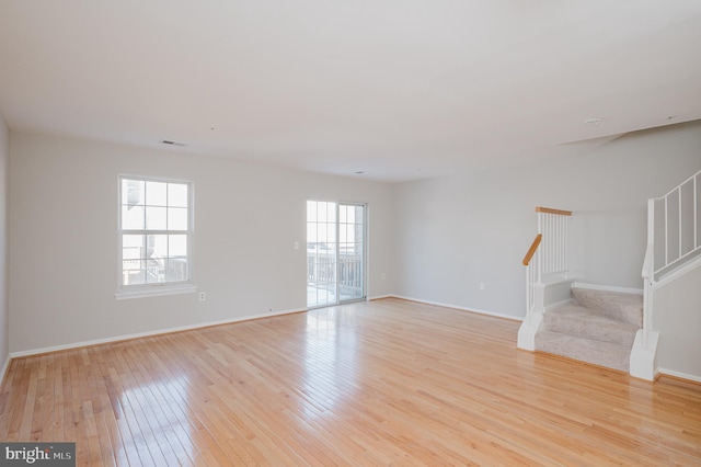 empty room with light hardwood / wood-style flooring