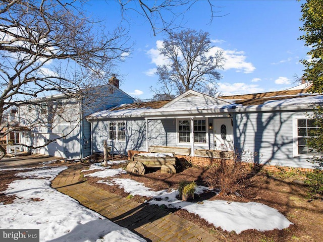 snow covered property featuring covered porch