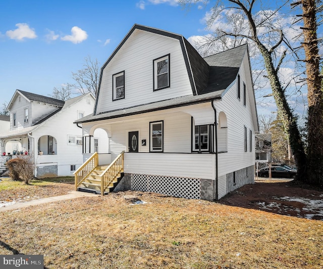 view of front of home featuring covered porch and a front lawn