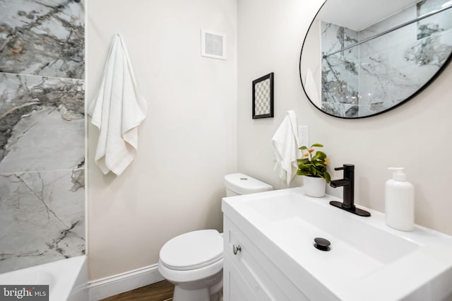 full bathroom featuring vanity, toilet, tiled shower / bath combo, and hardwood / wood-style floors