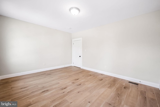 empty room with light hardwood / wood-style flooring