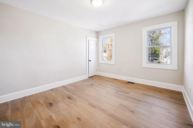 spare room with light hardwood / wood-style floors