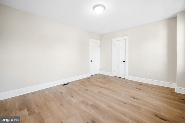 unfurnished room with light hardwood / wood-style floors