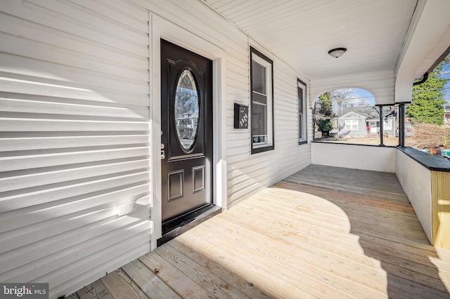 wooden terrace featuring covered porch