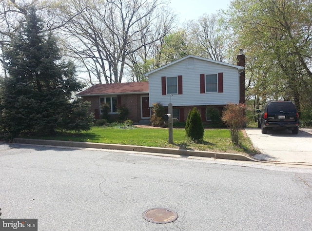 split level home with a front yard