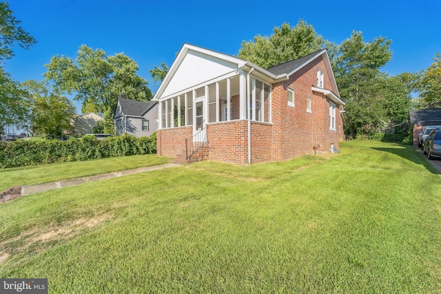 view of home's exterior with a yard