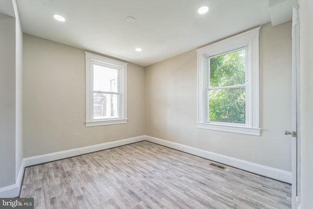 unfurnished room with light hardwood / wood-style flooring