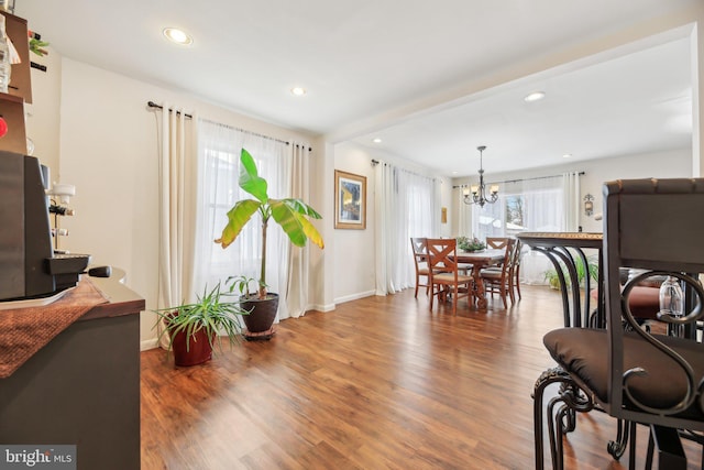 dining area featuring dark hardwood / wood-style flooring and a notable chandelier