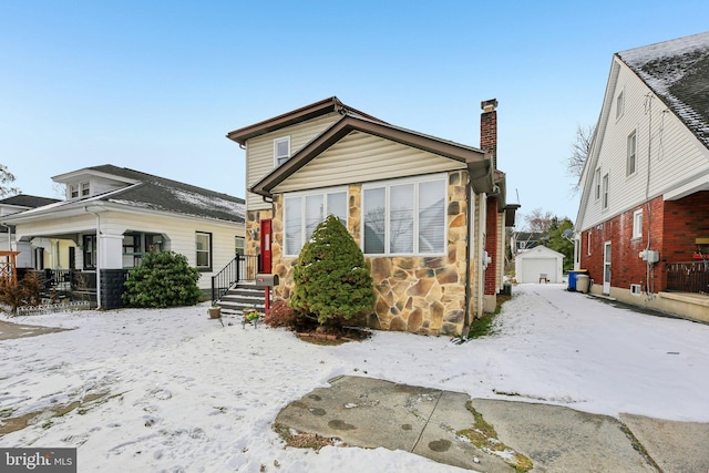 bungalow-style home featuring an outbuilding and a garage