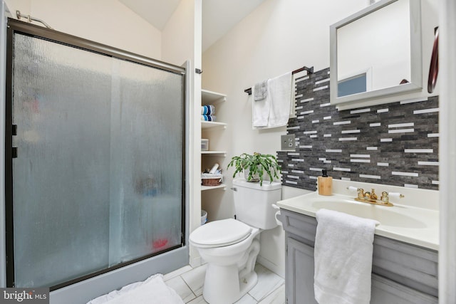 bathroom with backsplash, vanity, vaulted ceiling, toilet, and a shower with shower door