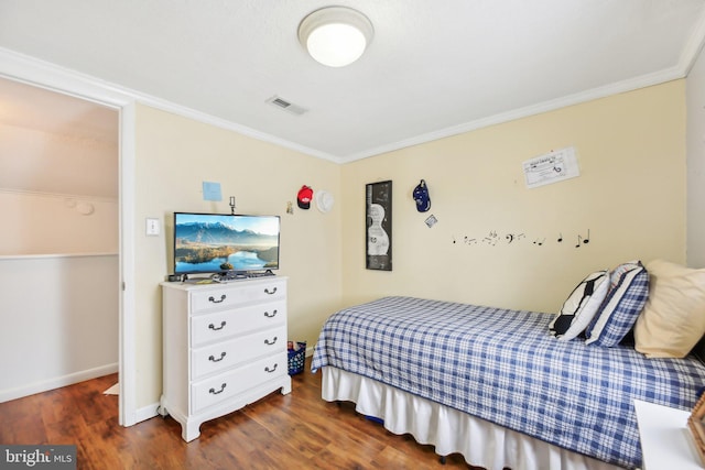 bedroom with ornamental molding and dark wood-type flooring