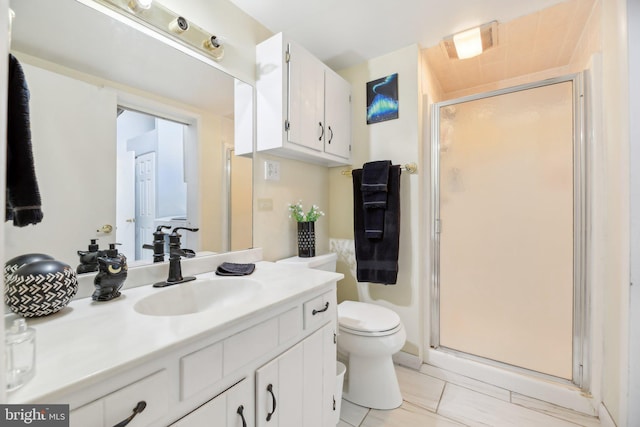 bathroom featuring tile patterned floors, vanity, an enclosed shower, and toilet