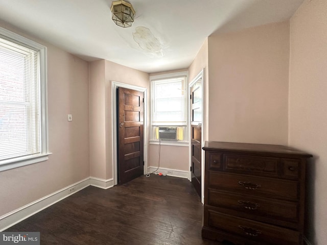 entryway featuring cooling unit, plenty of natural light, and dark wood-type flooring