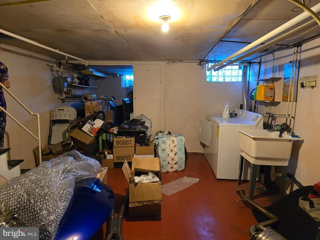 basement with separate washer and dryer and sink